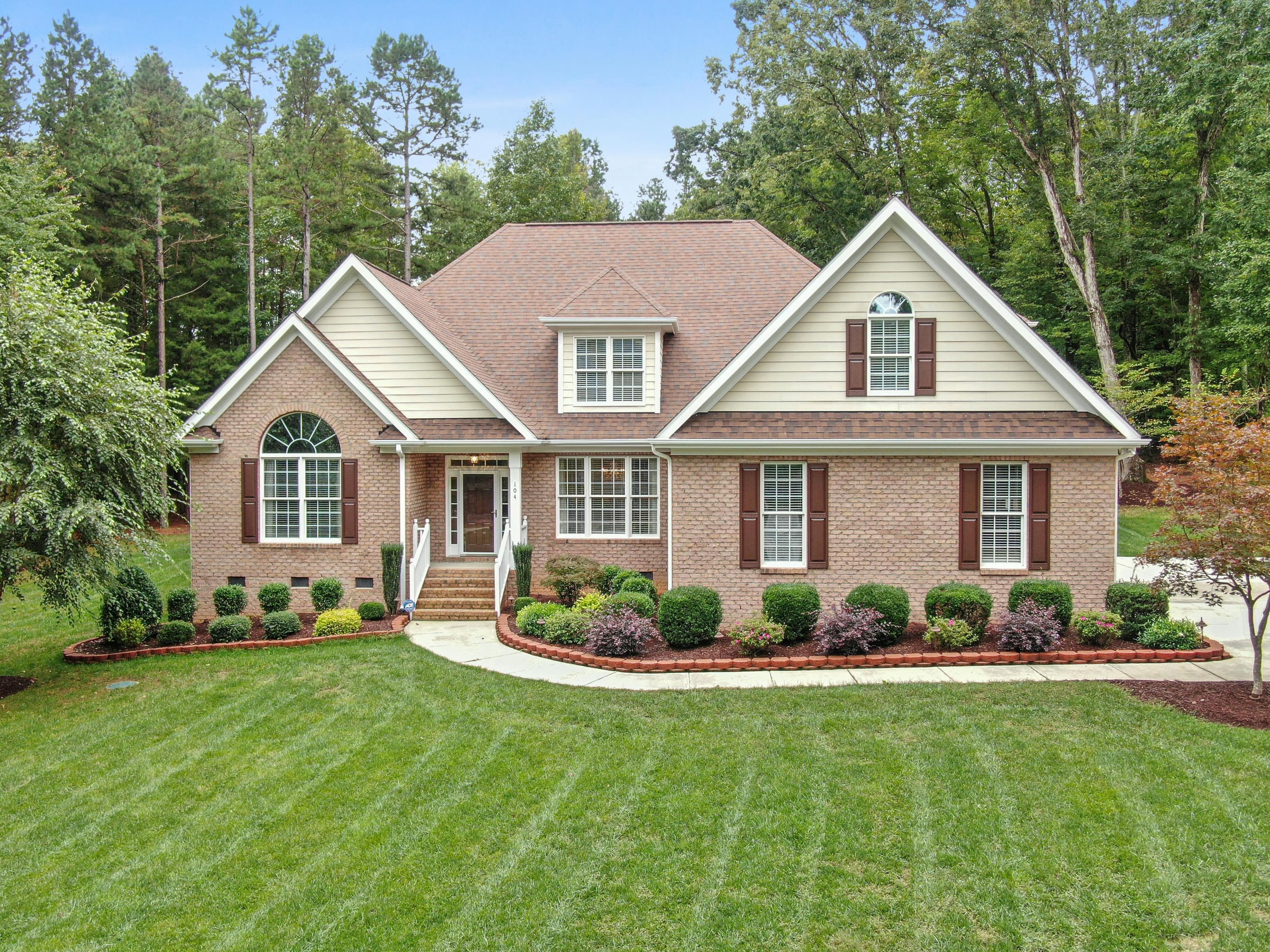 Residential home with professionally striped mowing pattern on the front lawn